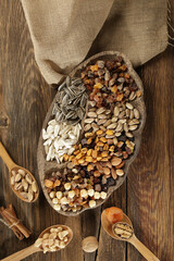 DRİED NUTS AND FRUİTS IN WOODEN BOWL ON BROWN FLOOR