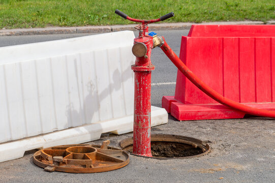 Water pump in open manhole