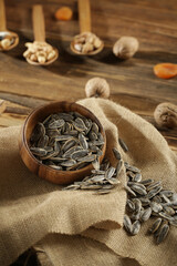 DRİED NUTS AND FRUİTS IN WOODEN BOWL ON BROWN FLOOR