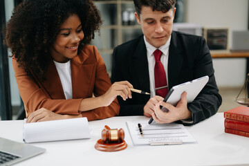 Business and lawyers discussing contract papers with brass scale on desk in office. Law, legal services, advice,  justice and law concept ...