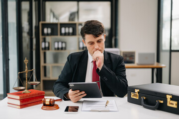 Mature man lawyer working and gavel, tablet, laptop in front, Advice justice and law concept. at office.