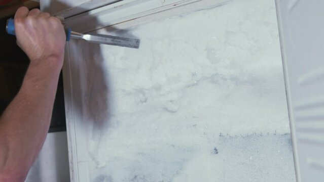 Chiseling ice from a completely blocked freezer