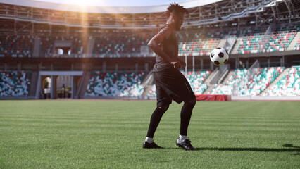 Obraz premium African American man playing football on the stadium field. A man runs with a soccer ball across the field.