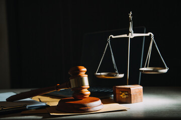 law legal technology concept. judge gavel on computer with scales of justice on desk of lawyer.