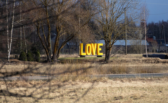 
a yellow sign that says love lies ahead.