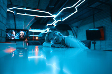 Portrait of a blonde in neon glasses.