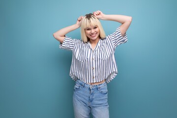 positive blond 25 year old female person in a striped blouse and jeans