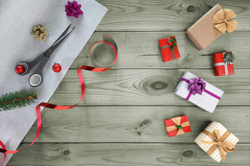 Preparing for Christmas and New Year. Gift wrapping and decorating for winter holidays. Gift boxes and packaging set on wooden background. Homemade Christmassy present. Template for article, shop.