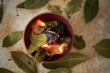 Burning bay leaves on vintage background