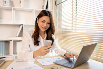 Young female college students talk on the phone and do homework at the same time, Happy home life, Work from home.