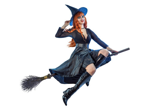 Halloween Witch flying on a broomstick. Female wizard fairy character for All Saints' Day. Fantasy gothic red-haired sorceress girl dressed in black carnival costume