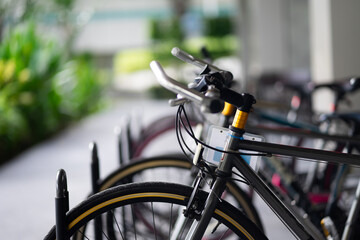 Many bicycles are lined up in the bicycle parking lot. light blurred background