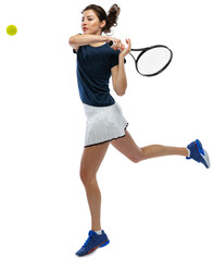 Full-length of young sportive girl, tennis player in motion hitting ball with racket isolated over...