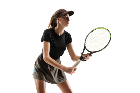 Sportive girl, tennis player in sportswear standing in position with racket during game isolated over transparent background. Concept of professional sport, competition, game, action, hobby.