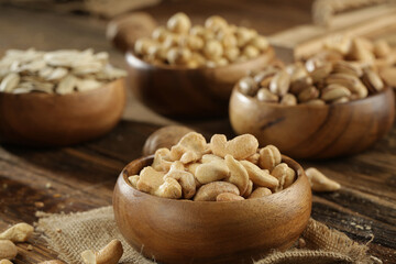 DRİED NUTS AND FRUİTS IN WOODEN BOWL ON BROWN FLOOR