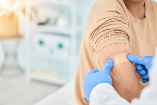 Bandaid, vaccine and patient with doctor for healthcare, first aid bandage or medical consultation for covid injection. Hands, hospital nurse and plaster for an injury, virus or injection in arm