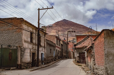 Fototapeta na wymiar View of a lonely street in a neighborhood in Potosi with the Cerro Rico in the background. Bolivia citylandscape. Southamerica