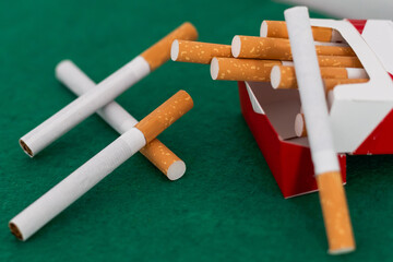 Heap of cigarettes on black background. Close up.