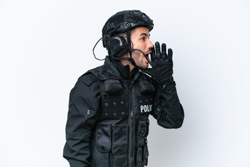 Fototapeta premium Young caucasian SWAT man isolated on white background shouting with mouth wide open to the lateral