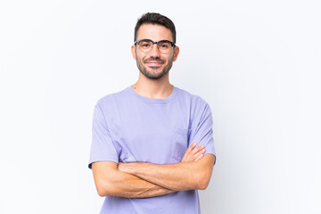 Young caucasian man isolated on white background keeping the arms crossed in frontal position