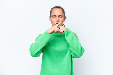 Young caucasian woman isolated on white background showing a sign of silence gesture
