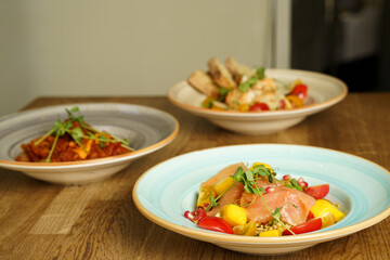 Tabbouleh salad with mango, colorful tomatoes and smoked salmon