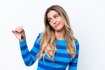 Fototapeta premium Young pretty Uruguayan woman holding home keys isolated on white background with sad expression