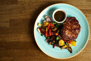Beef steak rub eye with grilled vegetables and chimichurri
