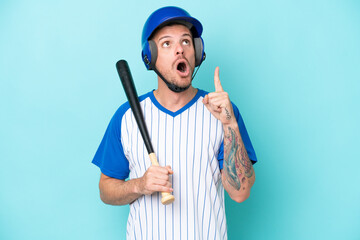 Baseball player with helmet and bat isolated on blue background thinking an idea pointing the...