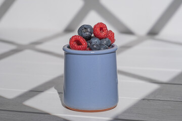 blueberries and raspberries in a cup