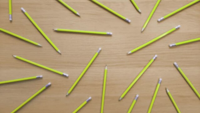 Blurred video background with colored pencils on wooden table. Animation with pencils changing color. Template or blank for adding text, element, design. Theme of school, office, fun, stationery sale.