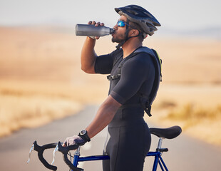Fitness, nature and man cyclist drinking water at race, marathon or competition training. Sports,...