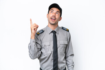 Young safeguard man over isolated white background pointing up and surprised
