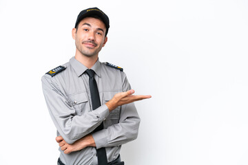 Young safeguard man over isolated white background presenting an idea while looking smiling towards