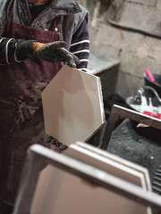 Crop craftsman working with hexagonal tiles