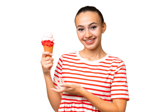 Young Arab woman with a cornet ice cream over isolated background extending hands to the side for inviting to come
