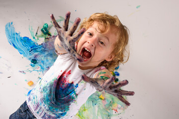 Astonished boy looking at dirty hands