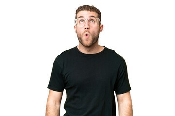 Fototapeta premium Young handsome blonde man over isolated chroma key background looking up and with surprised expression