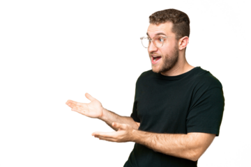 Young handsome blonde man over isolated chroma key background with surprise expression while looking side