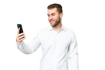 Young handsome blonde man over isolated chroma key background making a selfie