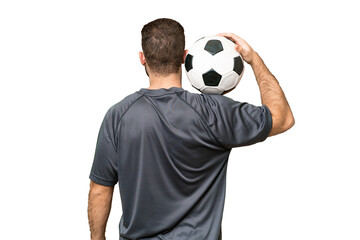 Young handsome blonde man over isolated chroma key background with soccer ball © luismolinero