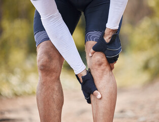 Fitness, knee pain and man hands in forest with cycling, sports or injury, muscle or joint accident...