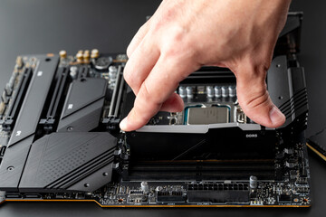 DDR5. Service work, assembly or modernization of the computer. The hand of the master installs a...