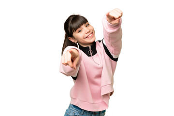 Little girl over isolated green chroma key background pointing front with happy expression