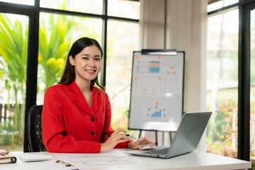 Young Asian businesswoman calculating tax invoice, loan interest rate, law firm, entrepreneur using financial calculator in home office