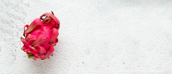 Ripe red dragon fruit on stone table