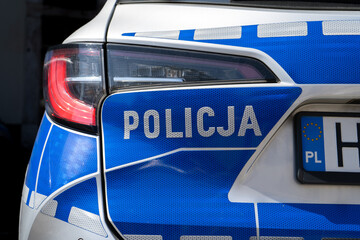Police sign on a police car in Poland. Letters in Polish language, Policja means Police. Polish officers patrol vehicle. © Longfin Media