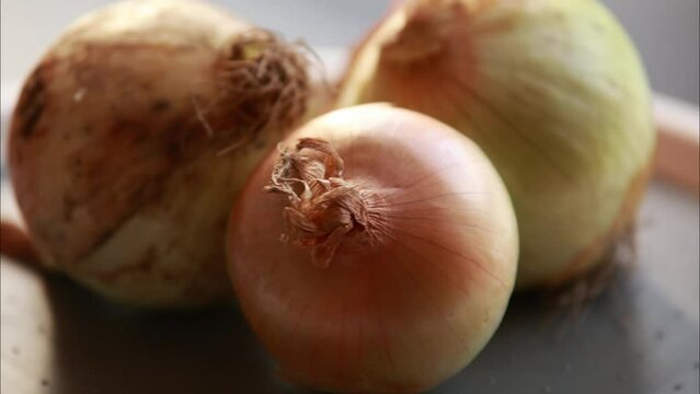 bunch of raw yellow onions close up