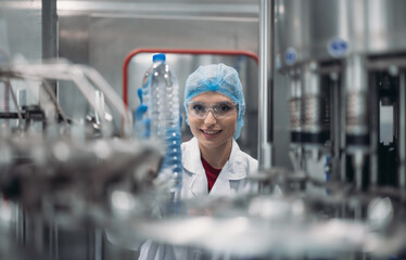 Supervisors check automated bottling for sequence accuracy, safety, reliability at water pipeline.