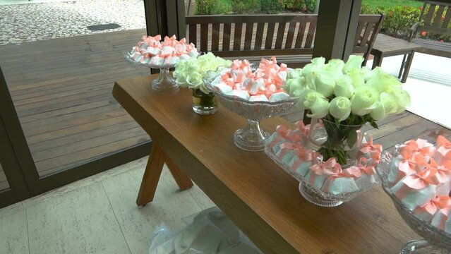 Bem-casado. candy table and well-married with flower arrangements. wedding and birthday sweets. 